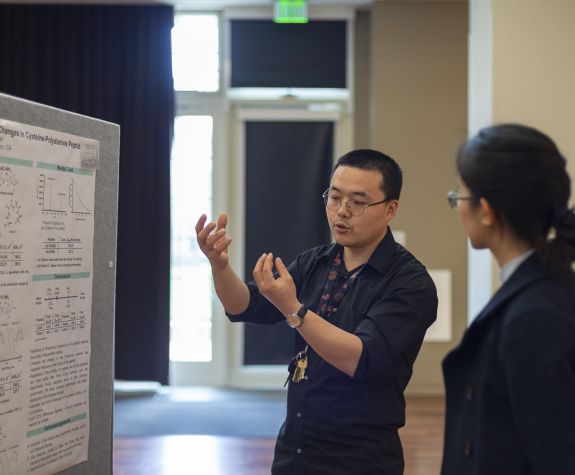 Student presenting a research poster
