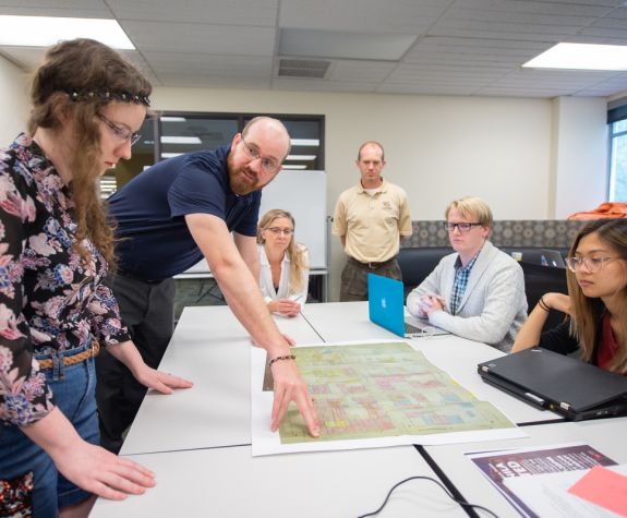 History professor and students working on a history project