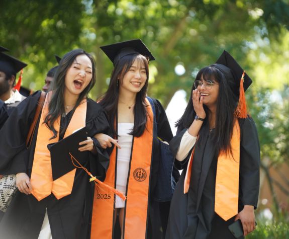 Three students dressed in Pacific commencement attire