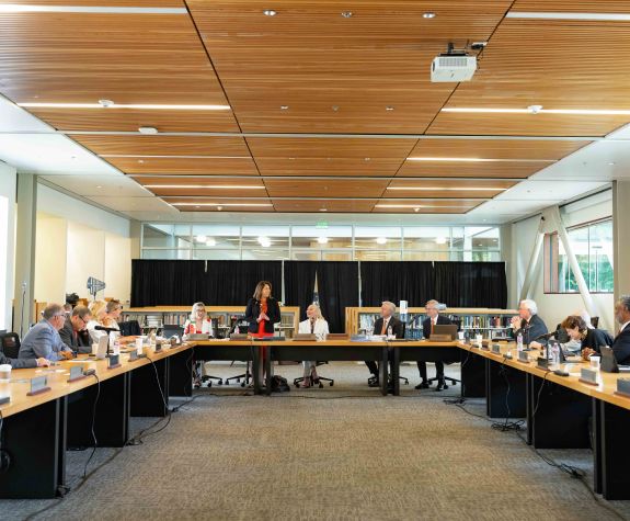 a board of regents meeting taking place in a large room
