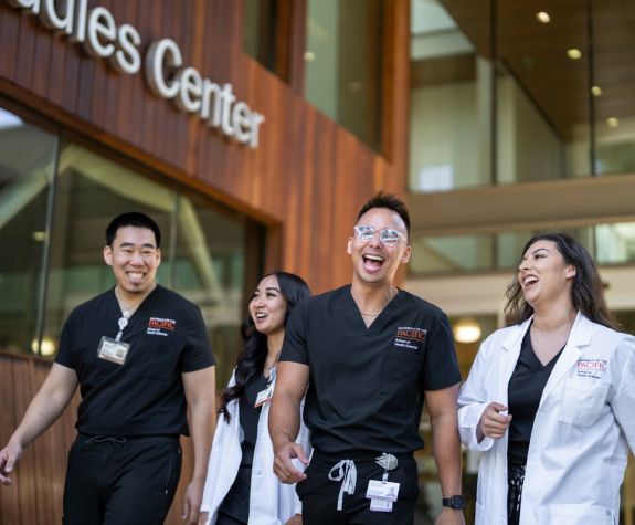 Graduate Health Science students in front of the Sacramento campus library