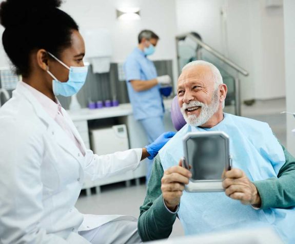 older man talking to dentist