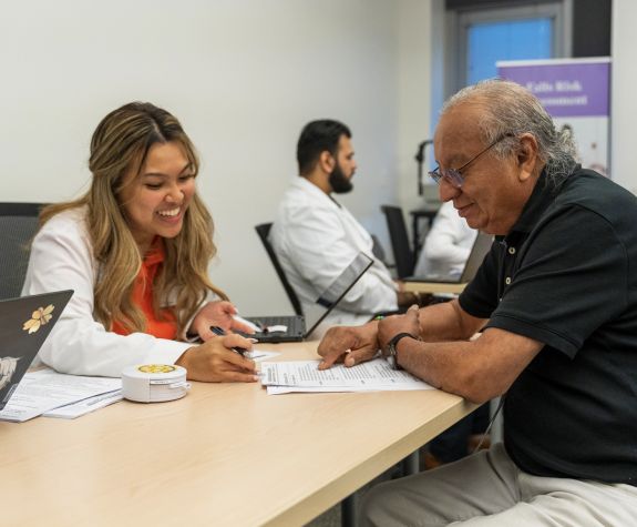 PharmD student with a patient at a Medicare Part D Outreach Clinic