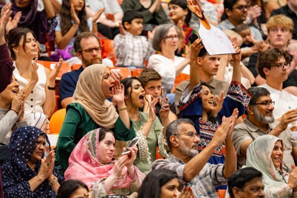 A large crowd cheers during commencement