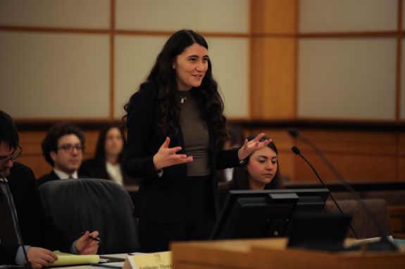 Student speaking in front of a panel.