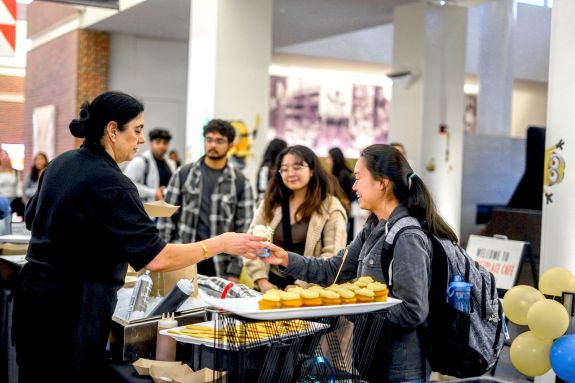 students picking up cupcakes in the marketplace