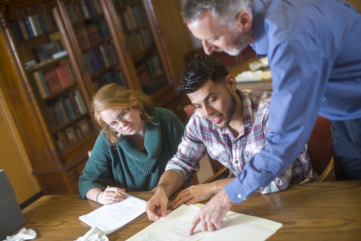 Students view archives with Special Collections staff