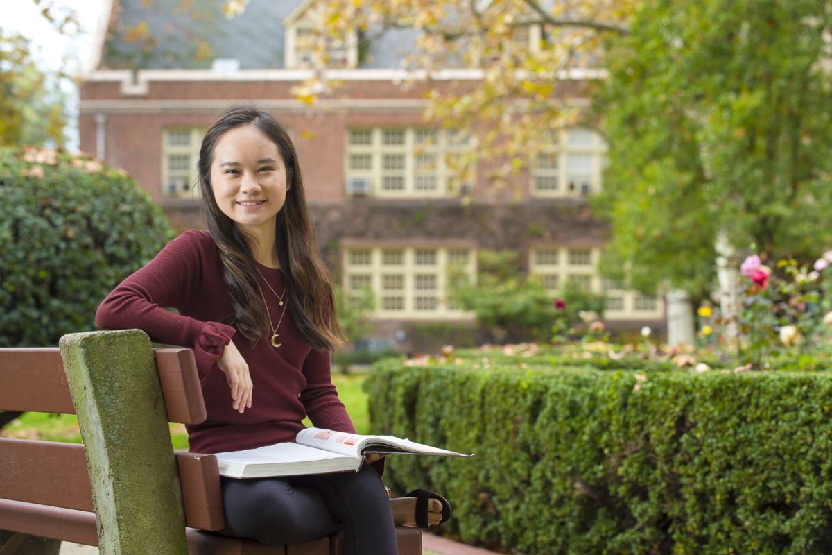 Language student sitting on bench