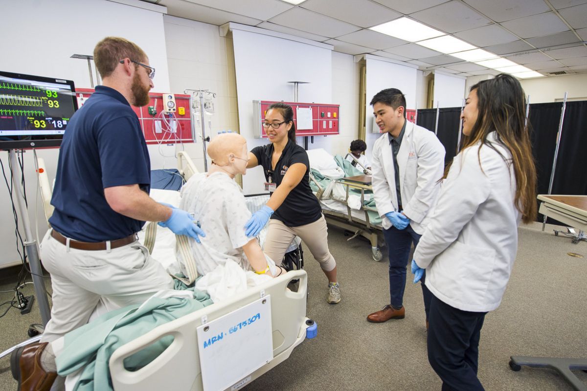 Physical therapy, pharmacy and speech language pathology students run through patient case studies in the simulation lab as part of an interprofessional education program