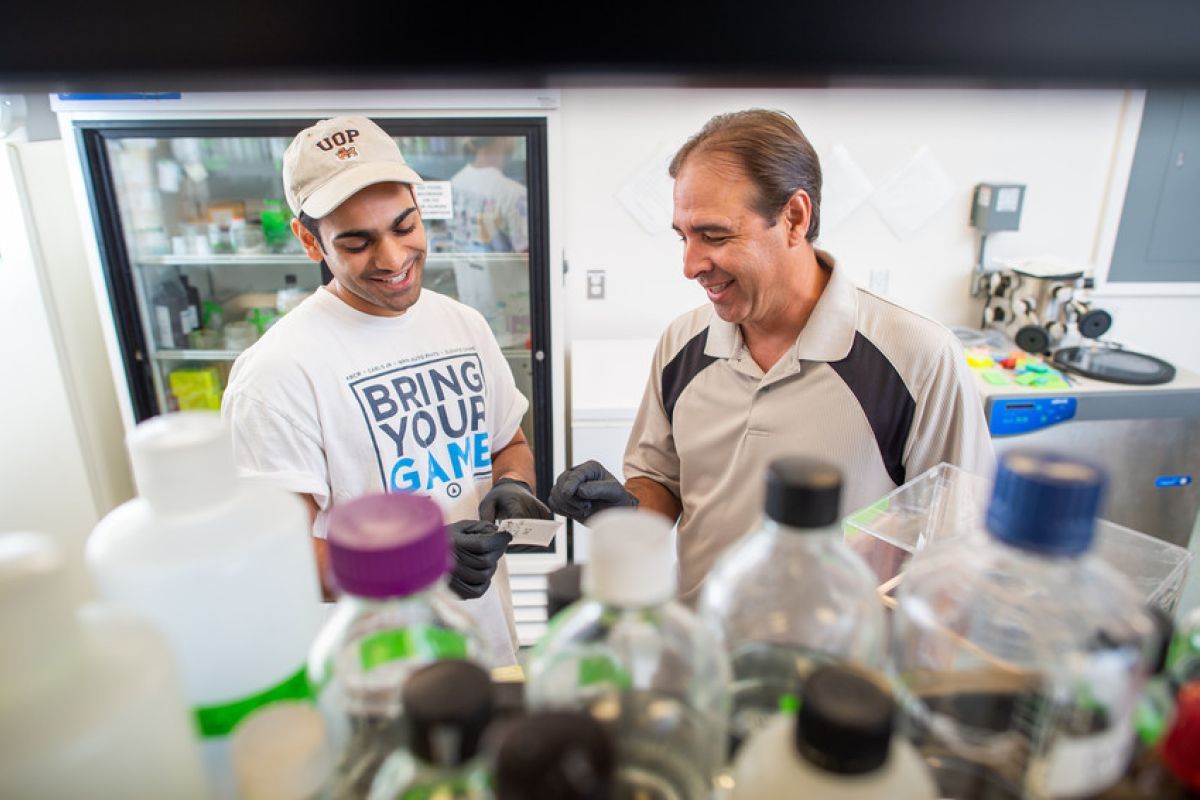 student and professor in the lab