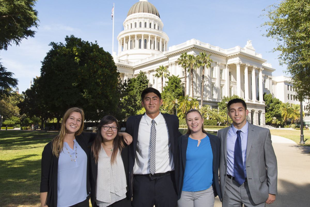 students standing in front of state capitol