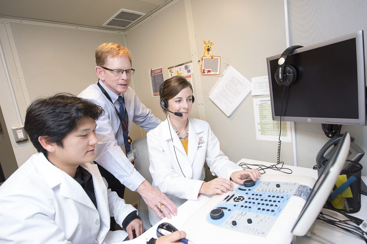 audiology professor and students in lab
