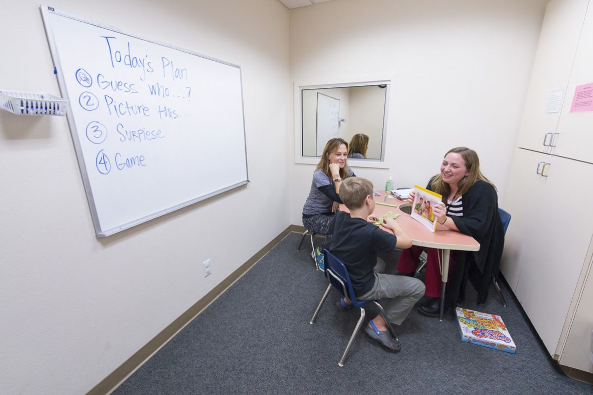 child works with Samantha Sheppard at the Scottish Rite Childhood Language Disorders Center.