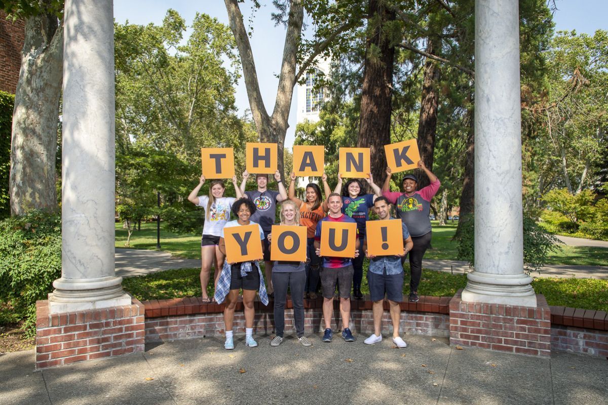 students holding thank you signs
