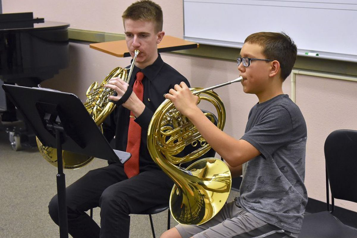 two music students practicing the horn