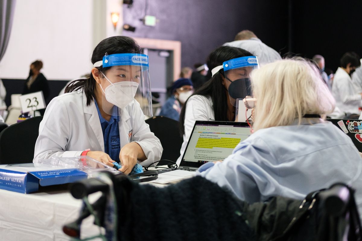 a student assists a patient at a diabetes clinic
