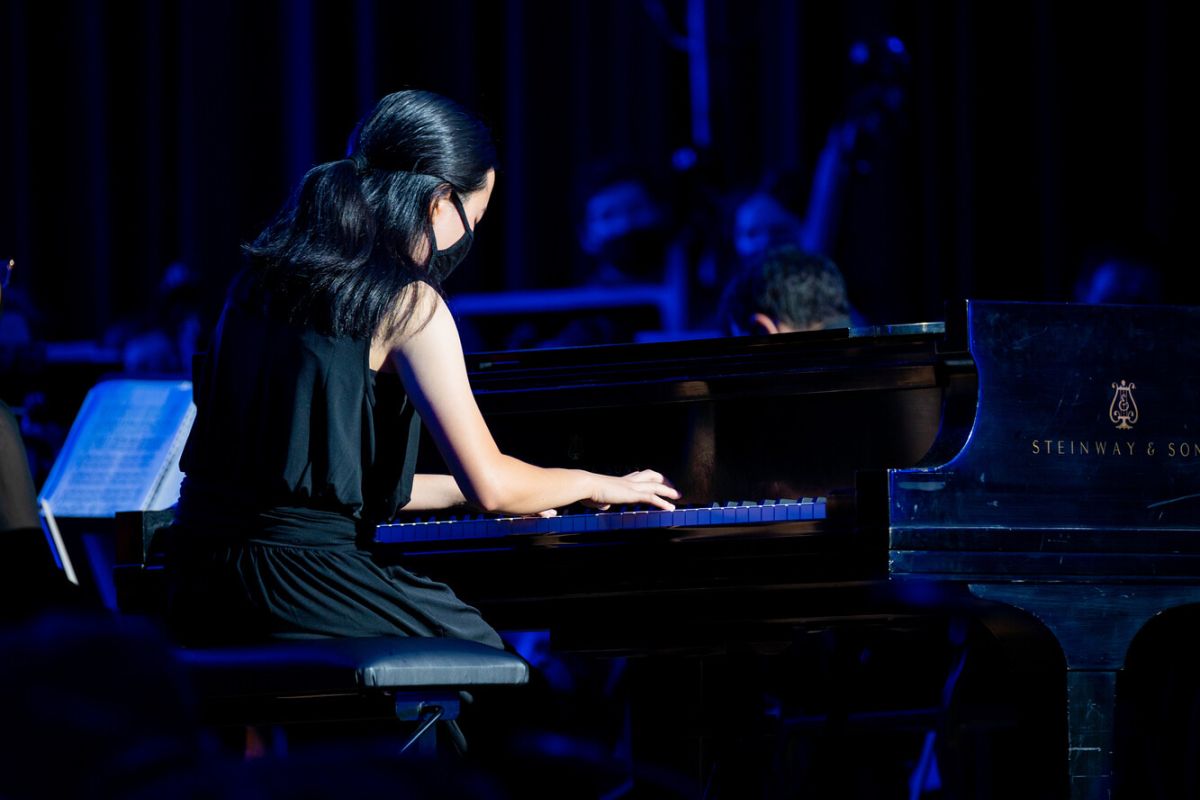 A Pacific student playing the piano