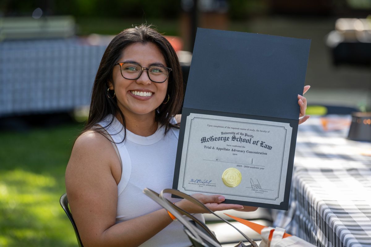 student holding a certificate