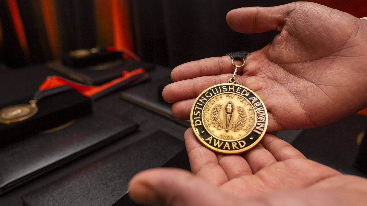 Hands holding medallion