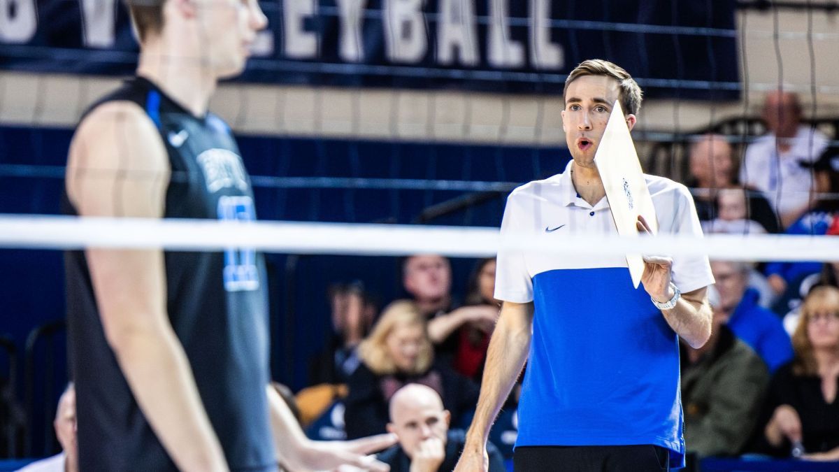 Devin Young coaches a player on the court