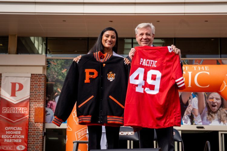 Chief People Officer Harpreet Basran and Pacific President Christopher Callahan exchange jerseys during a kick off celebration. 