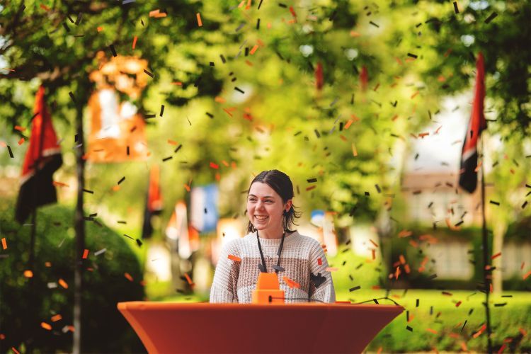 a student is showered with confetti