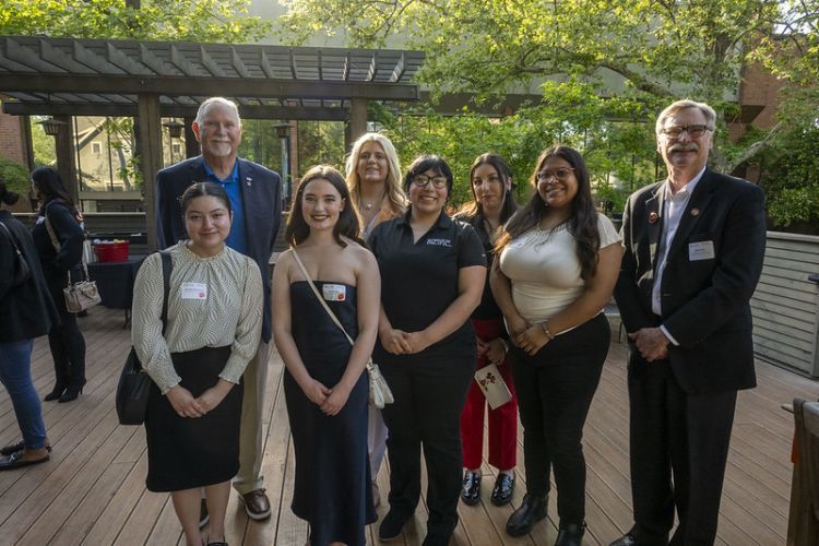 A group of people at an outdoor networking event. 