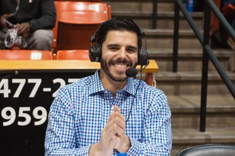Zach Bayrouty sits with a headset on