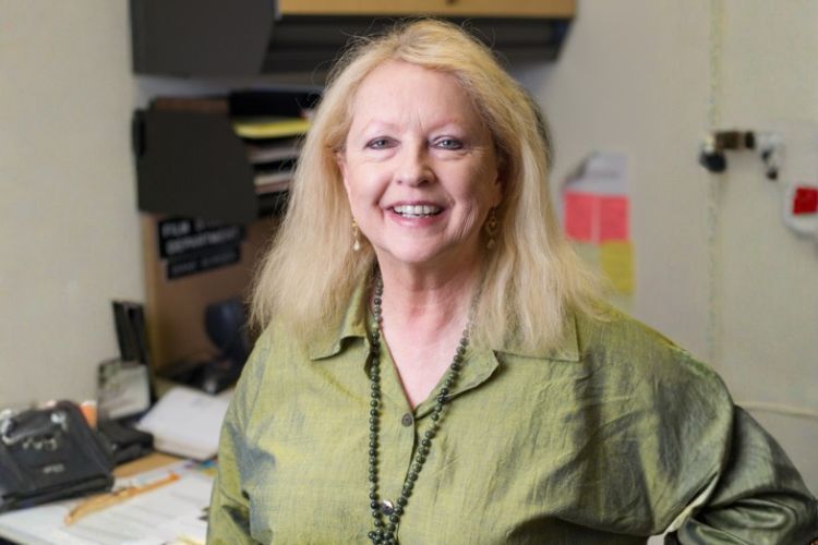 Diane Borden smiles in a classroom