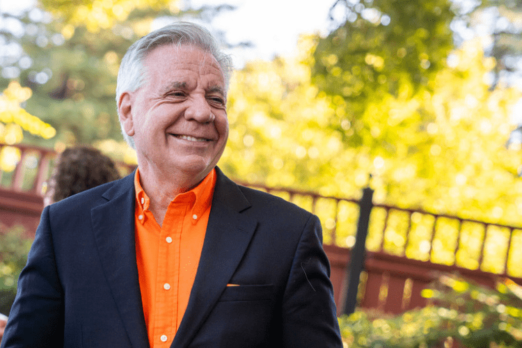 President Callahan in an orange shirt outside 