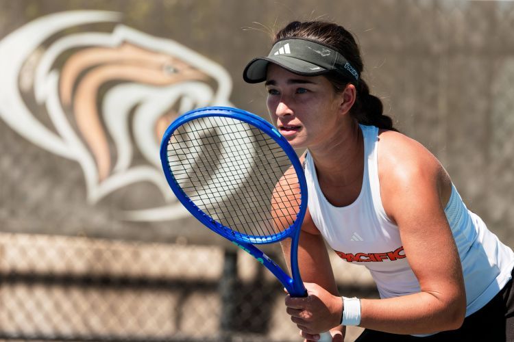 Indiya McLeod ’27 holds a racket and prepares to hit the ball