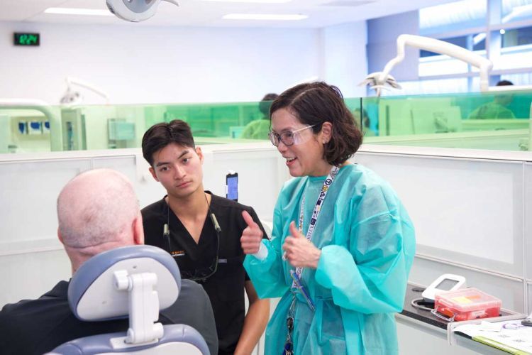 veteran in the dental chair talking to volunteers