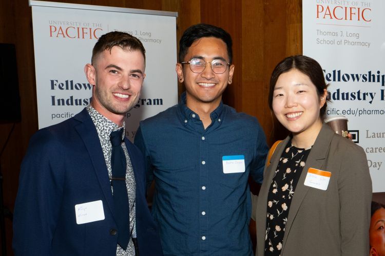 Three individuals at networking mixer 