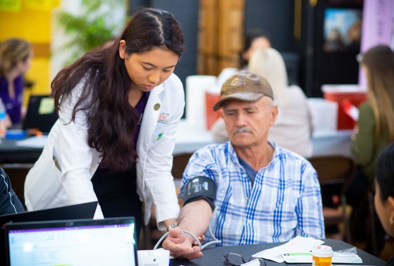 student helps patient