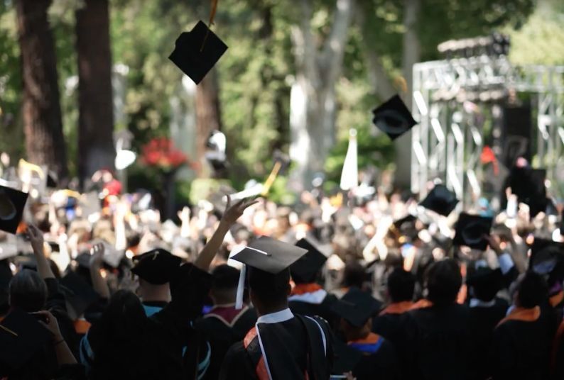 graduates throwing their caps in the air