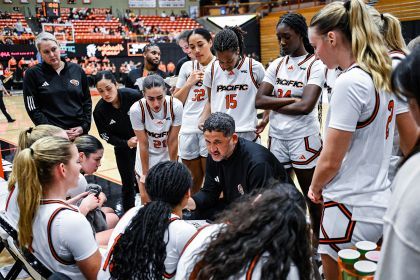 Bradley Davis on the court surrounded by his team