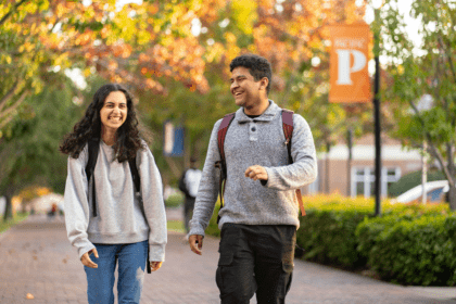 Two students walking on campus