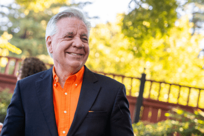 President Callahan in an orange shirt outside 