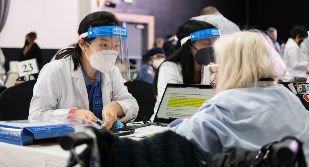 a student assists a patient at a diabetes clinic