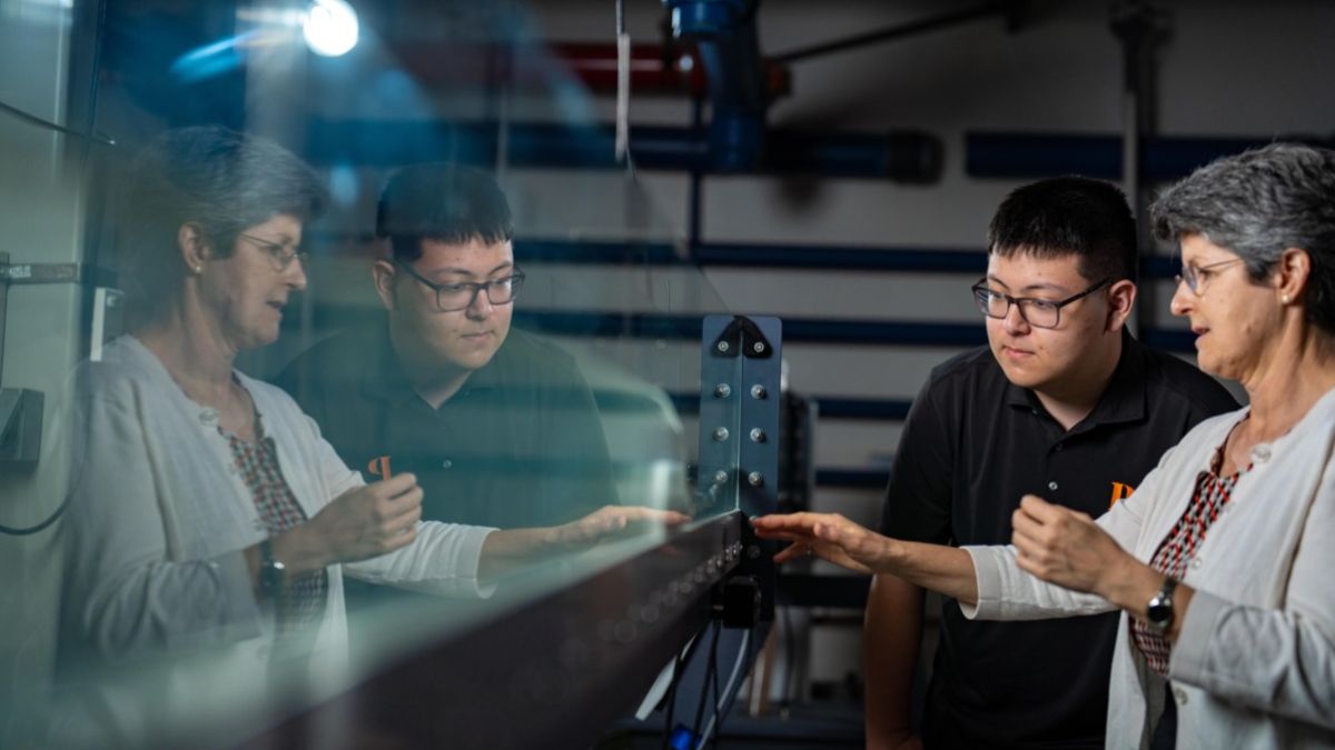 a student and professor in a hydraulics lab