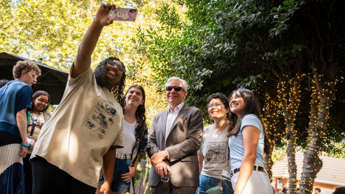 President Christopher Callahan poses for a photo with Pacific students. 