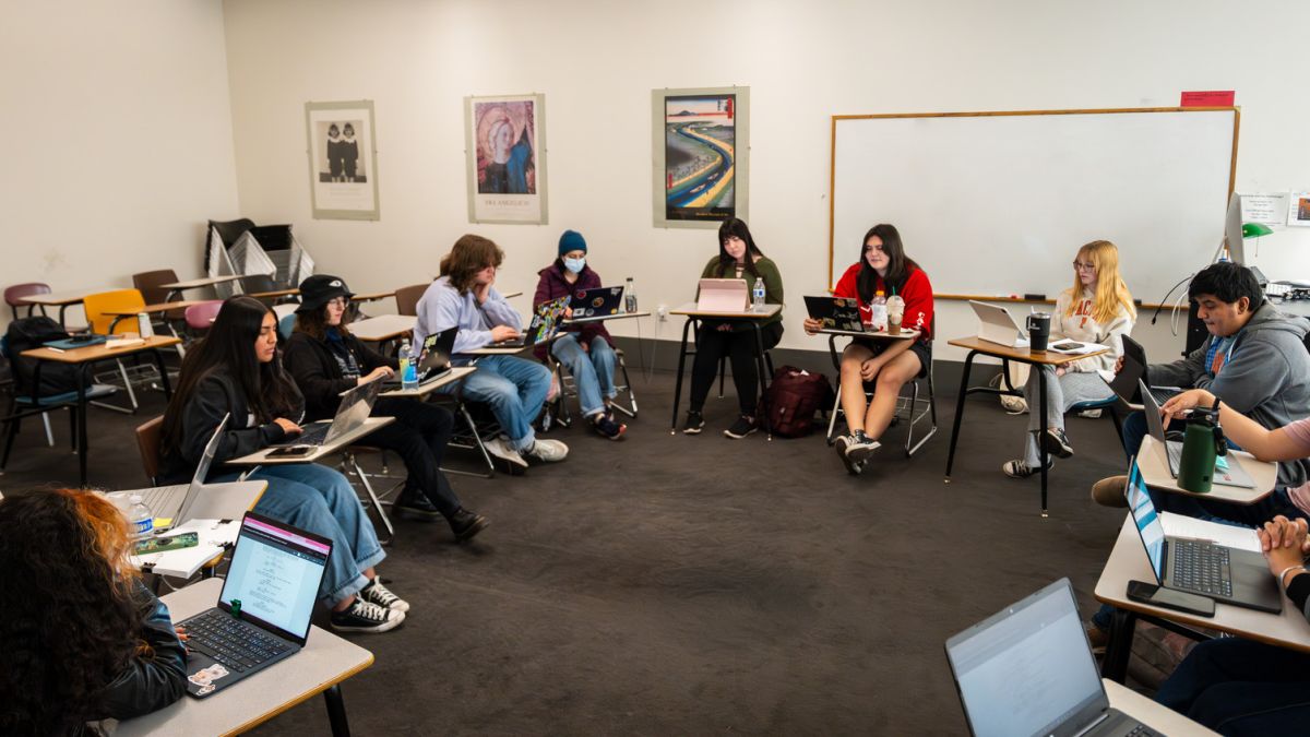 a group of students sits at desks in a classroom